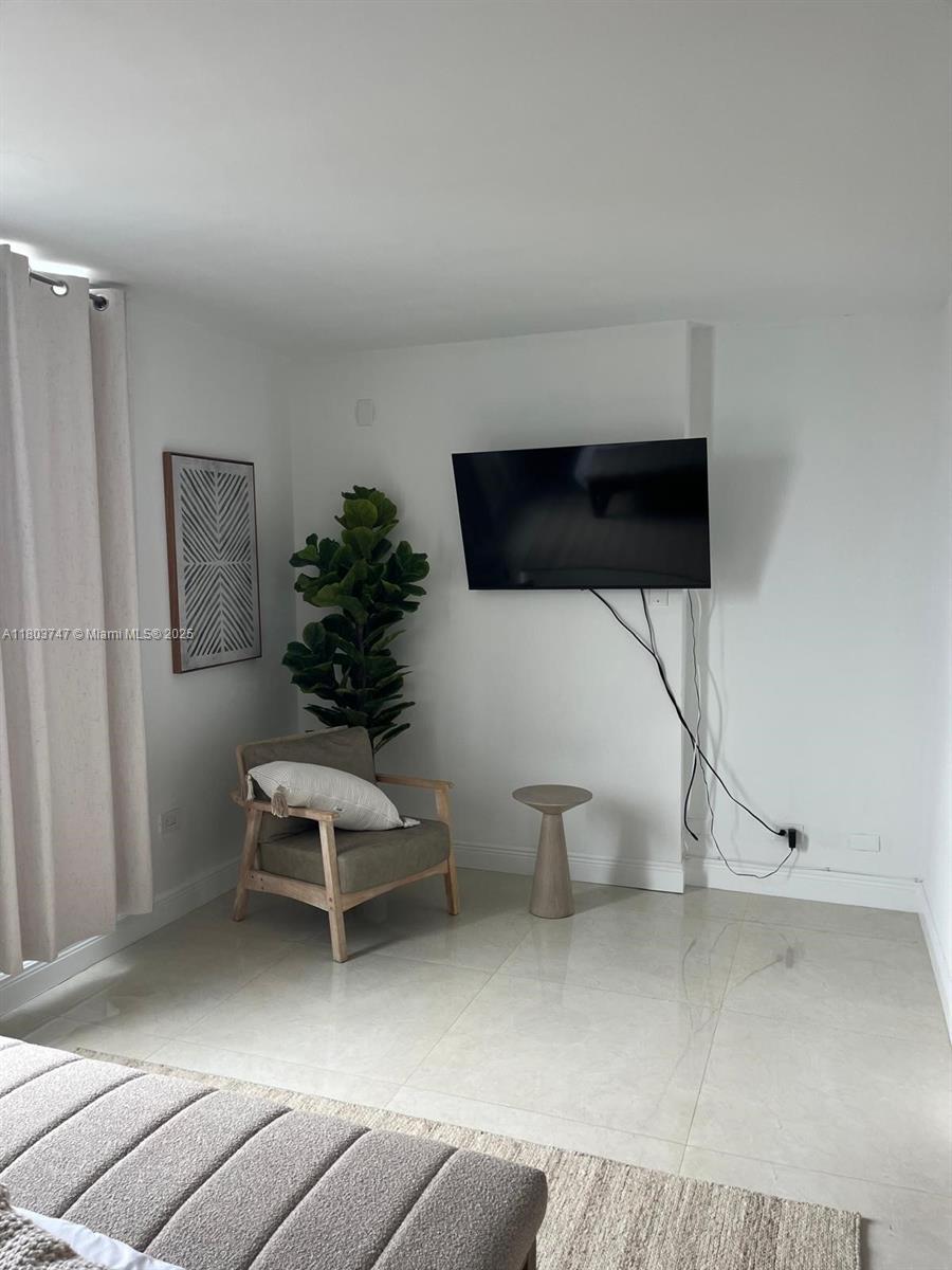 2301 Collins Avenue, Unit 731 Miami Beach, FL 33139 - Photo 22 of 31 a living room with furniture a air conditioner and a window