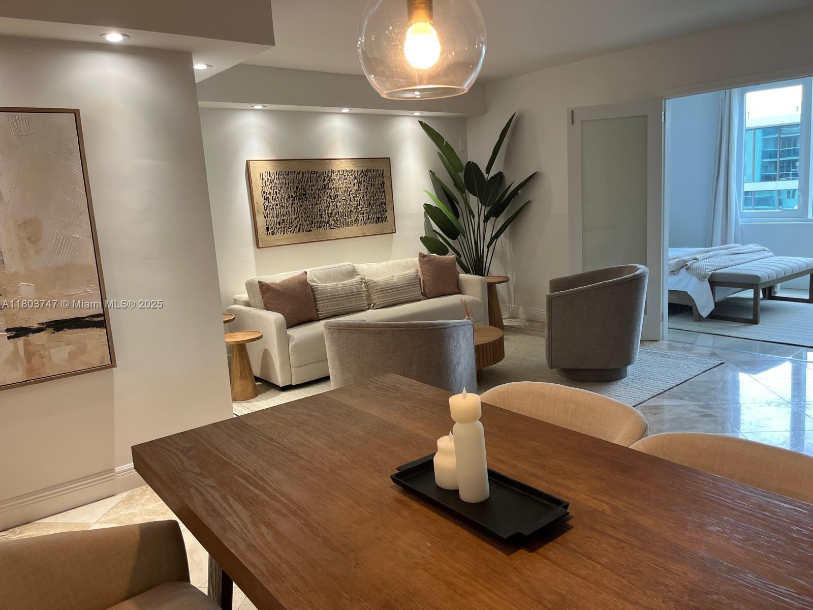 2301 Collins Avenue, Unit 731 Miami Beach, FL 33139 - Photo 25 of 31 a living room with furniture and a potted plant