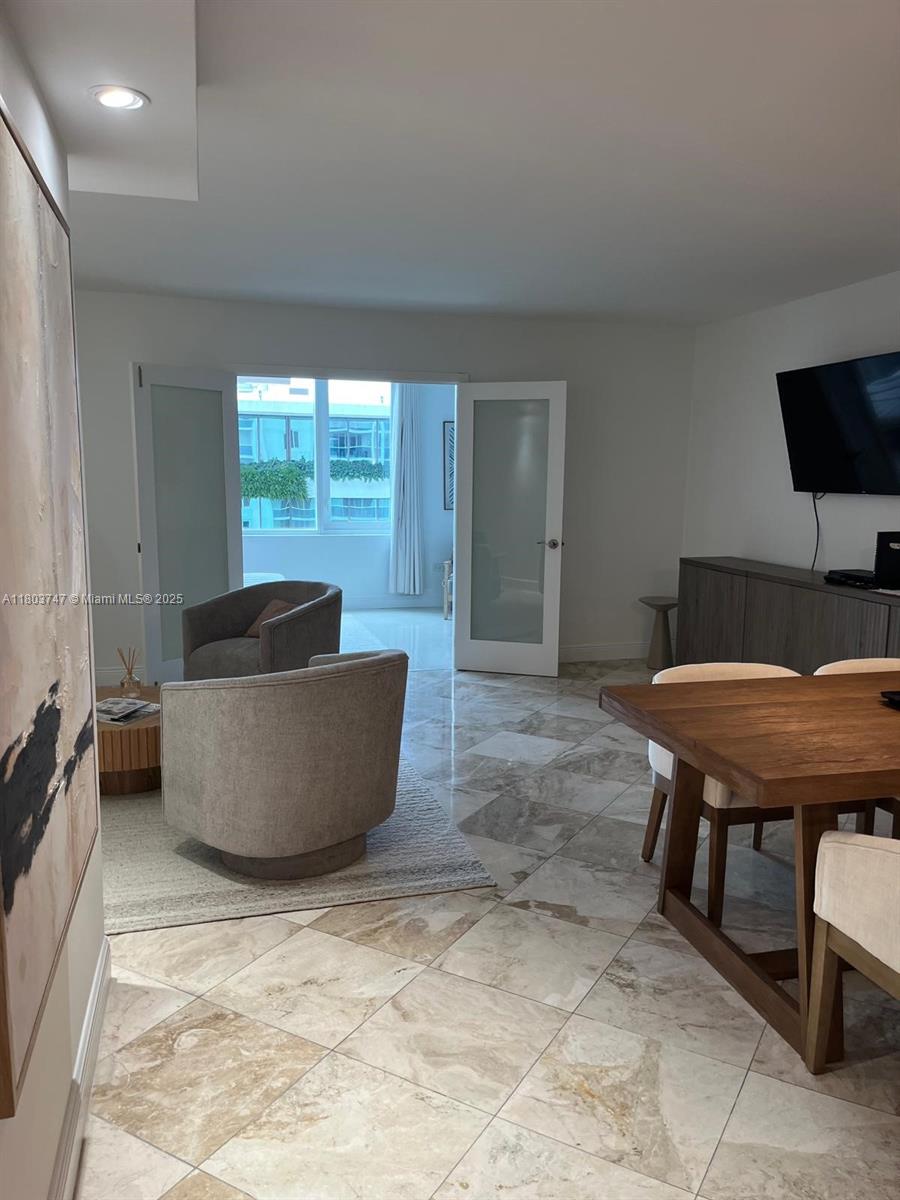 2301 Collins Avenue, Unit 731 Miami Beach, FL 33139 - Photo 26 of 31 a living room with furniture and a flat screen tv