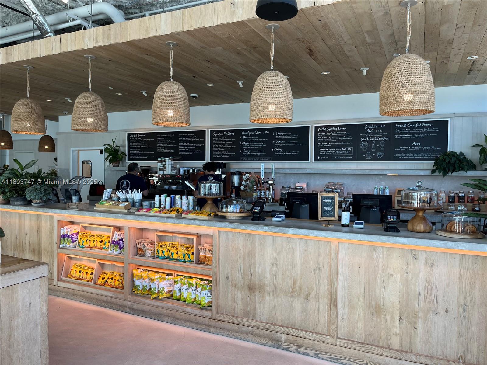 2301 Collins Avenue, Unit 731 Miami Beach, FL 33139 - Photo 27 of 31 a kitchen with stainless steel appliances granite countertop a sink and wooden cabinets