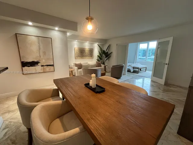 a dining room with furniture and wooden floor