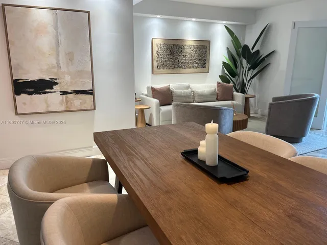 a living room with furniture flowerpot and wooden floor