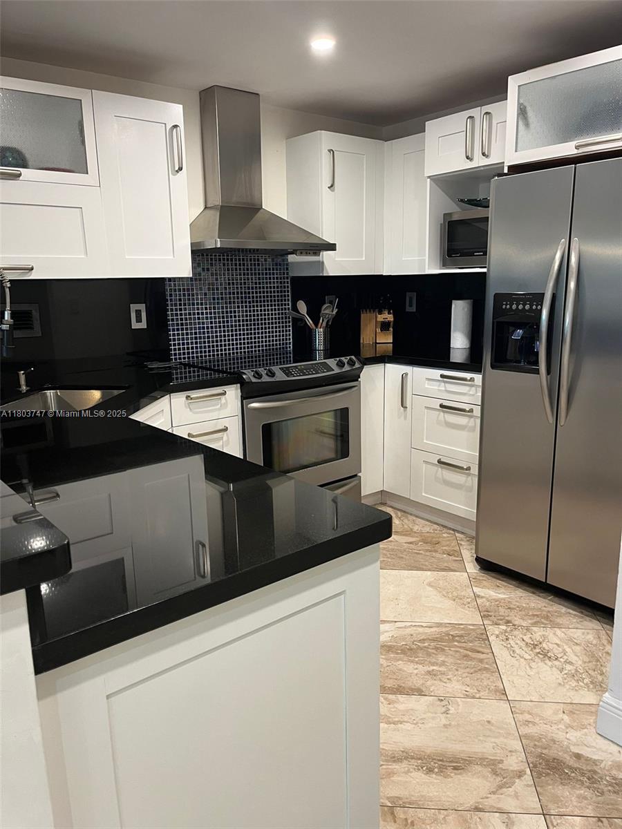 2301 Collins Avenue, Unit 731 Miami Beach, FL 33139 - Photo 7 of 31 a kitchen with stainless steel appliances granite countertop a stove a sink and a refrigerator