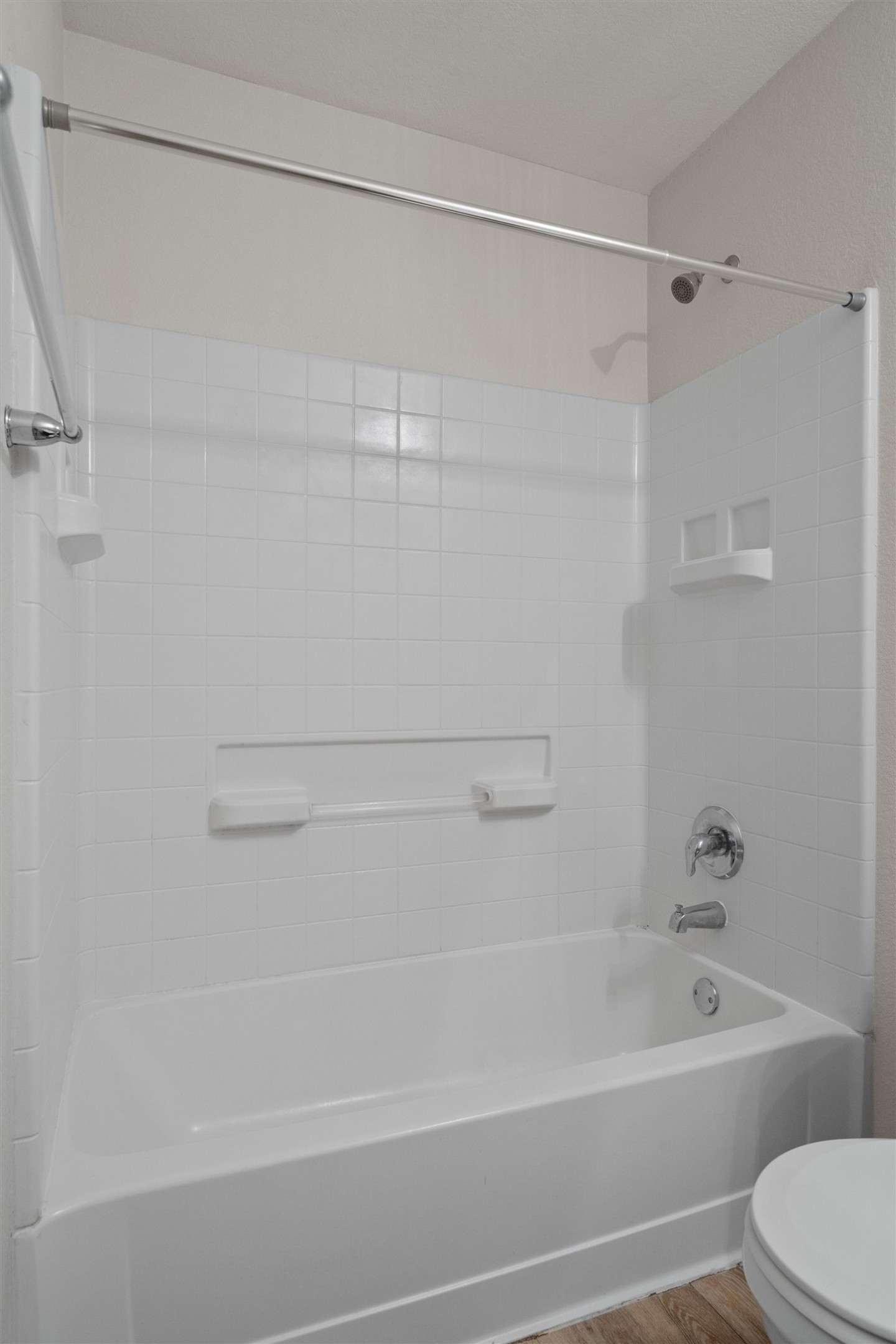 5825 Silver Screen Drive Austin, TX 78747 - Photo 25 of 40 A pristine white tile surround complements the classic bathtub and shower fixture, ready for daily rejuvenation.