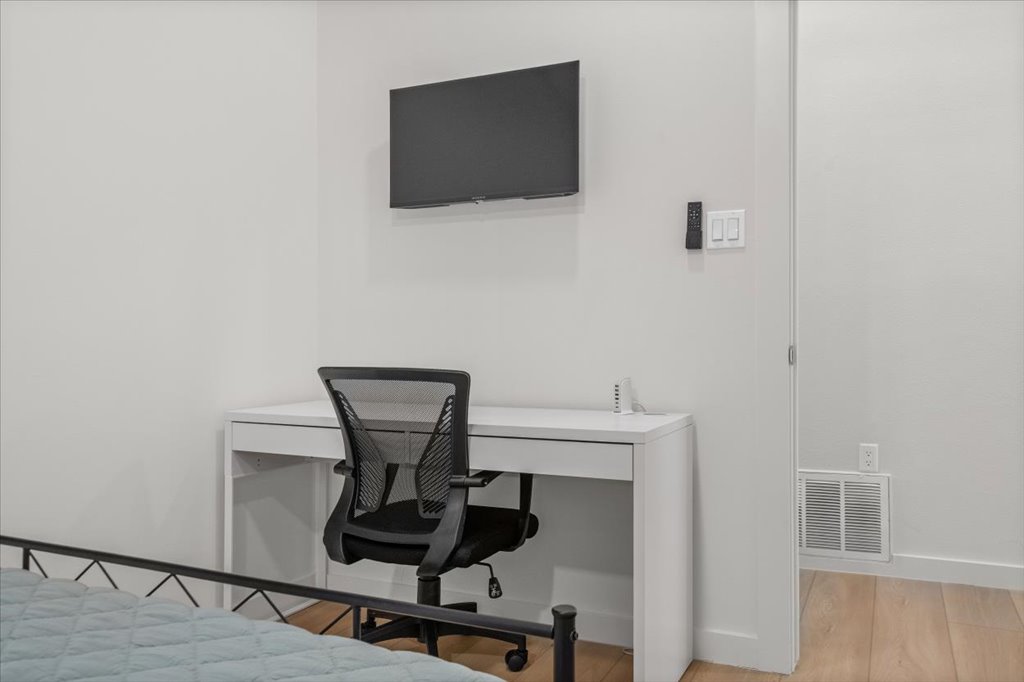 1406 North Georgetown Street Round Rock, TX 78664 - Photo 15 of 34 A well-appointed office nook features a sleek desk and a wall-mounted display for convenience.