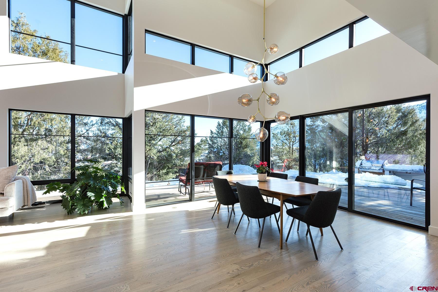 12 Falcon Way Durango, CO 81301 - Photo 8 of 35 a view of a dining room with furniture large windows and wooden floor