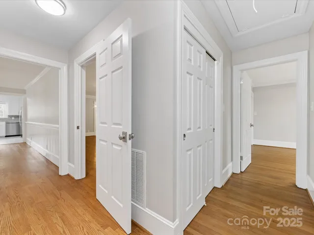 a view of a hallway with wooden floor and staircase