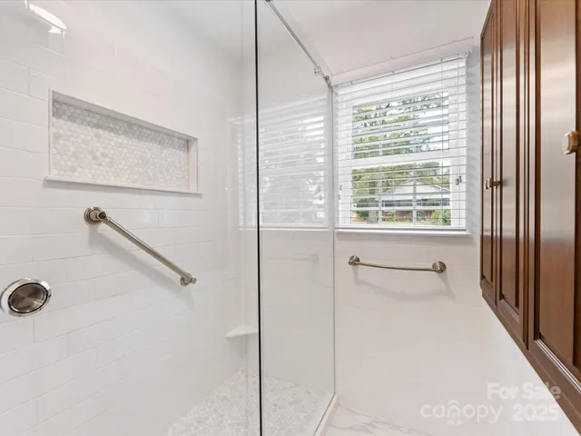 a bathroom with a shower and a window