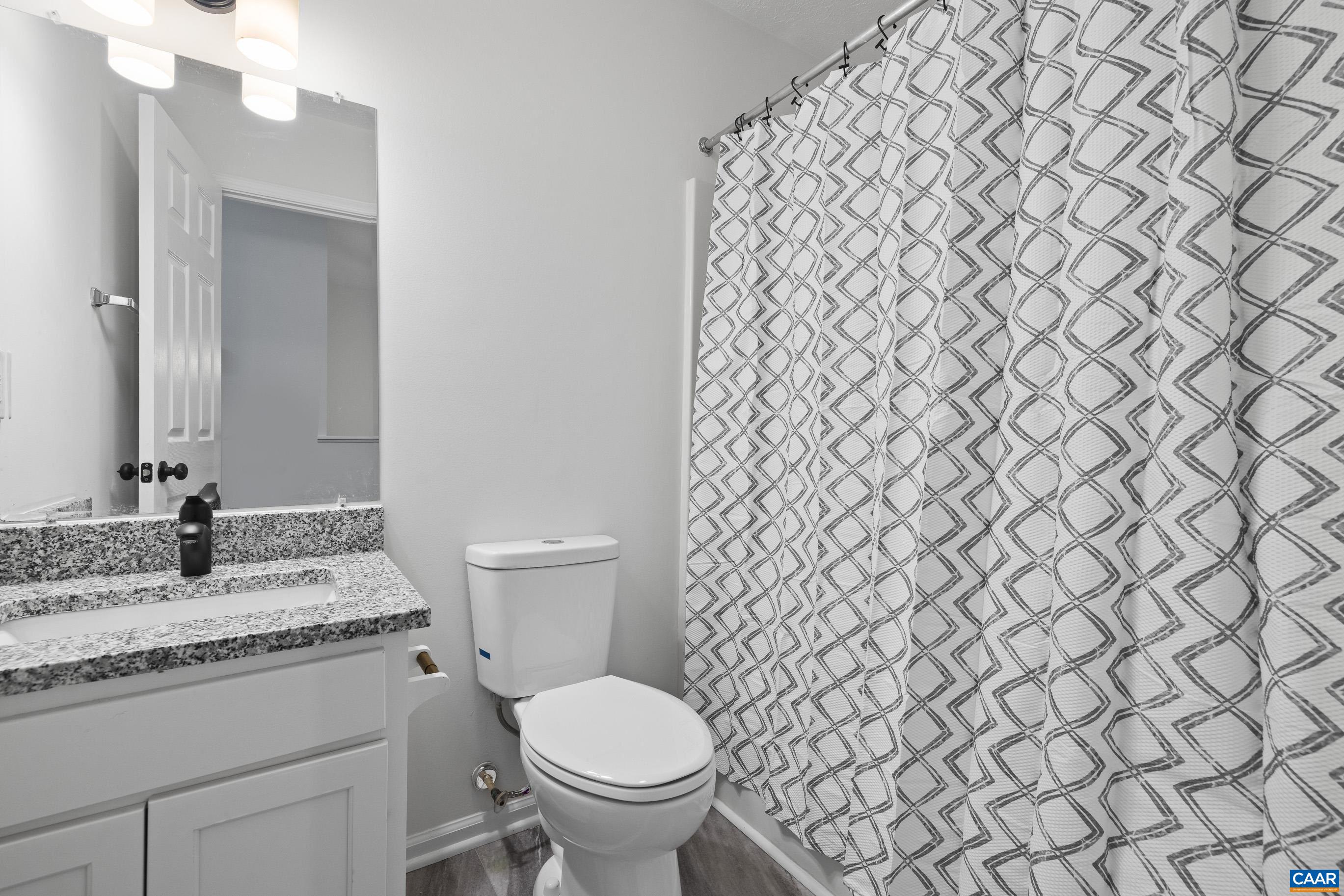 33 Brougham Road Palmyra, VA 22963 - Photo 24 of 49 a bathroom with a granite countertop toilet and a sink