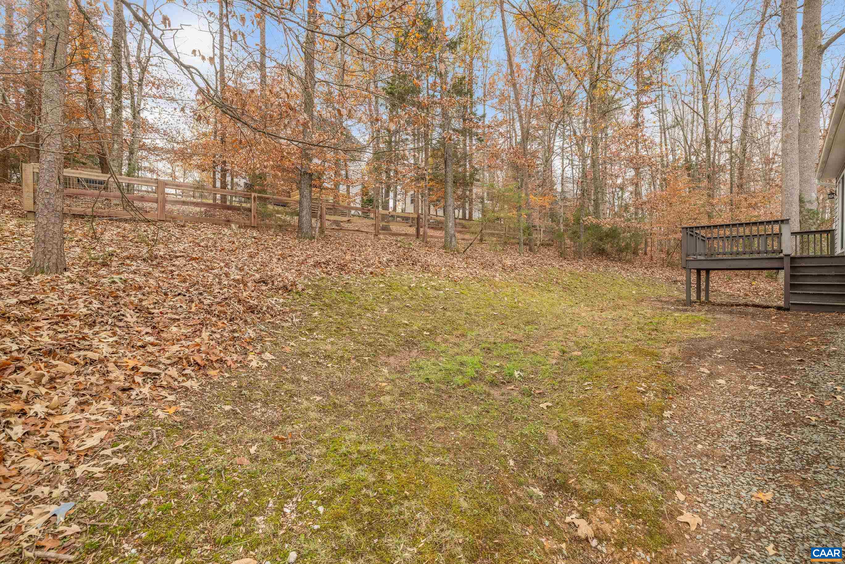 33 Brougham Road Palmyra, VA 22963 - Photo 36 of 49 a backyard of a house with lots of green space and bench