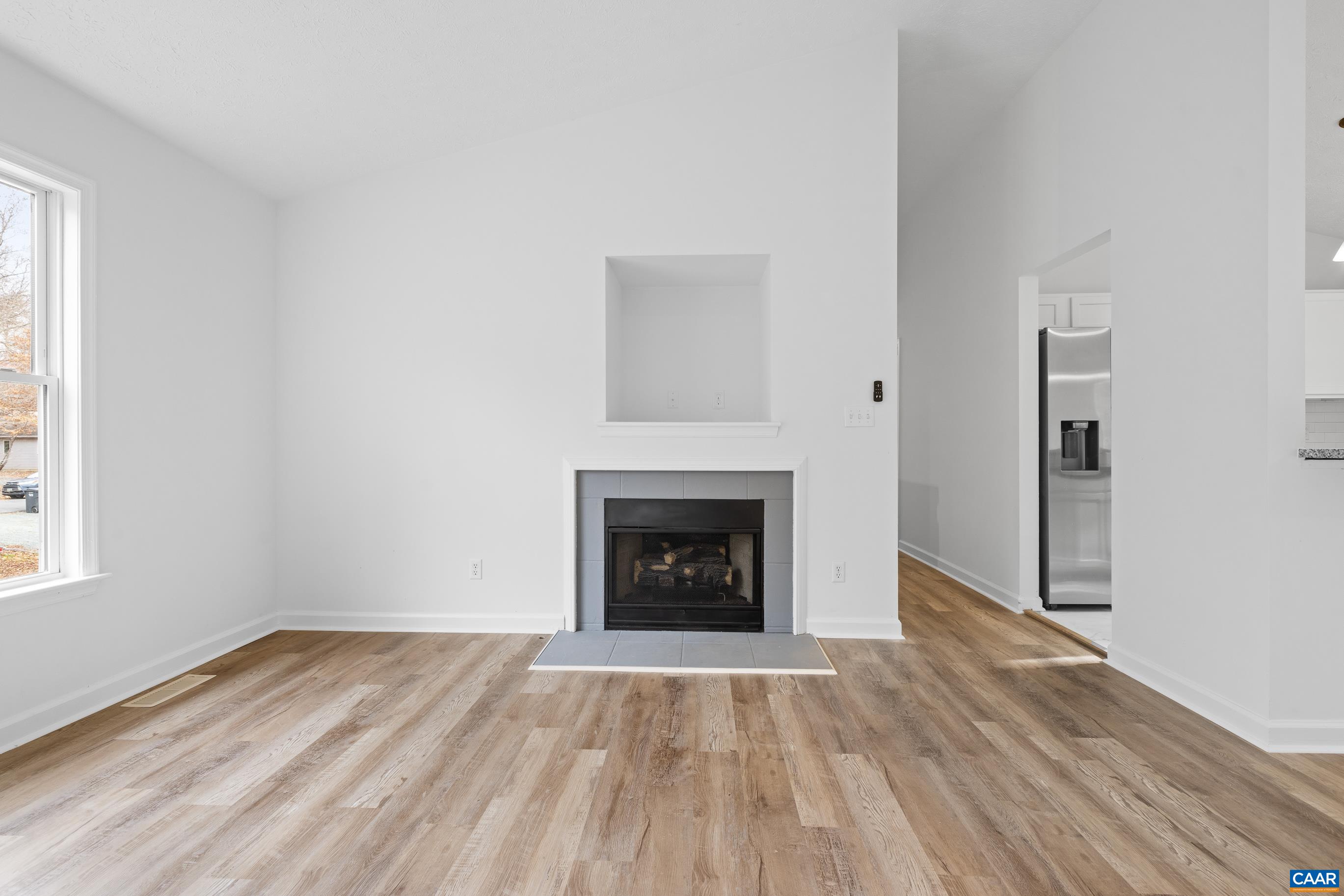 33 Brougham Road Palmyra, VA 22963 - Photo 5 of 49 a view of an empty room with wooden floor fireplace and a window