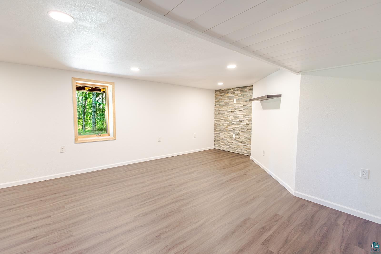 29 Ridge Road Esko, MN 55733 - Photo 26 of 41 Spacious room featuring wood-finish flooring, recessed lighting, and a window with wood trim