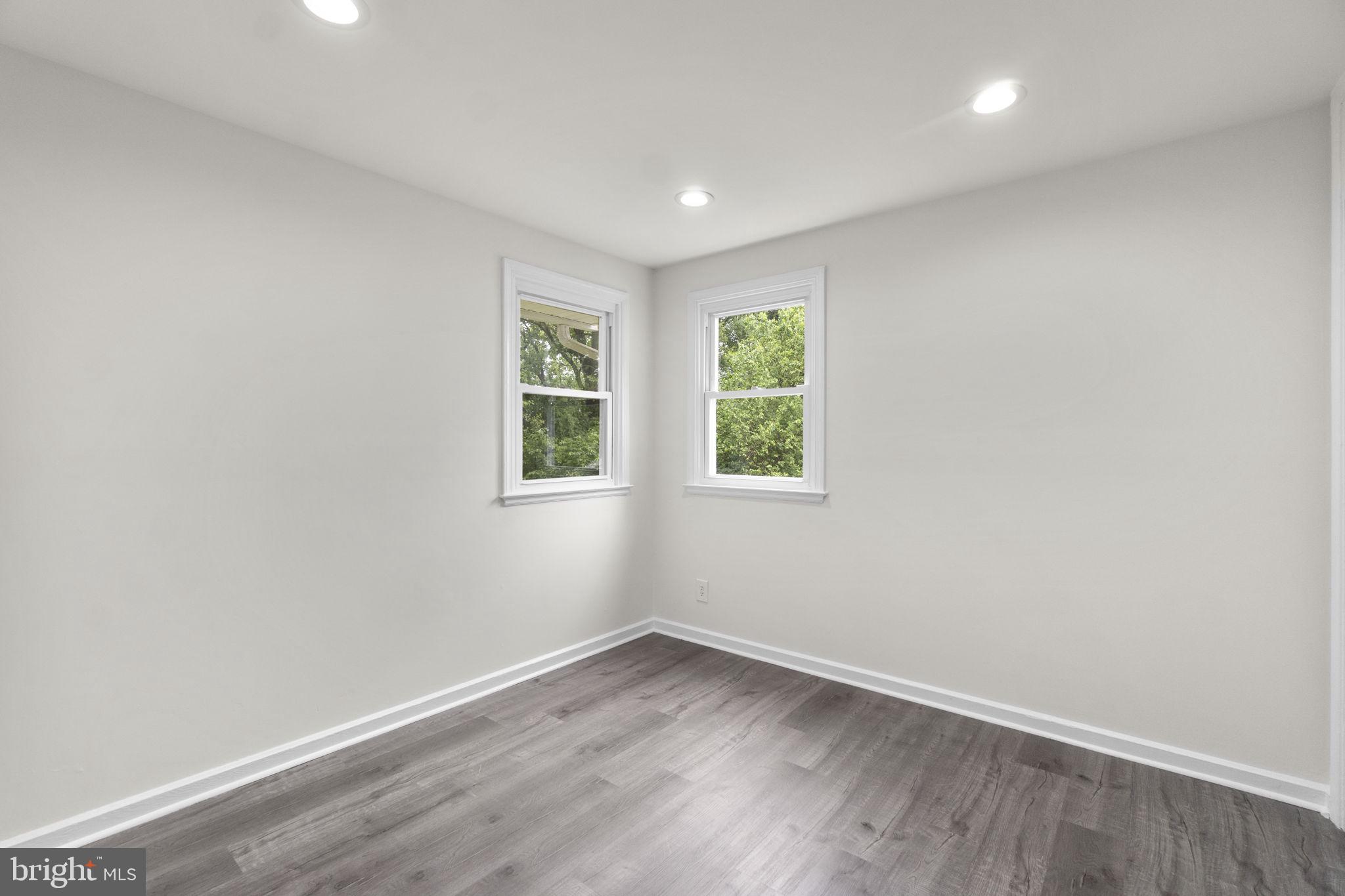 3658 Clifmar Road Baltimore, MD 21244 - Photo 25 of 43 an empty room with wooden floor and windows