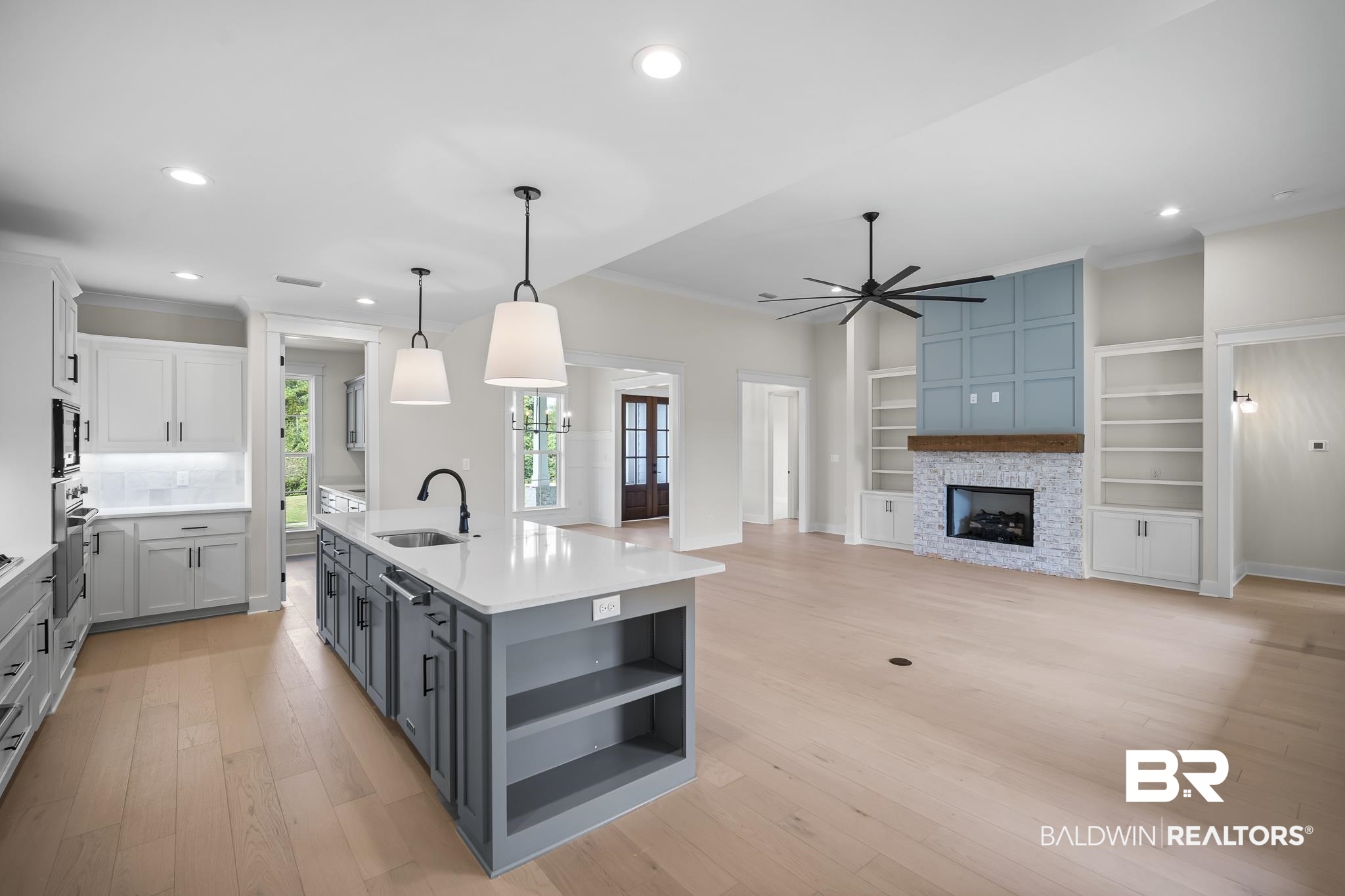 21826 Veranda Boulevard Fairhope, AL 36532 - Photo 8 of 42 Kitchen featuring open shelves, recessed lighting, a center island with sink, light wood finished floors, and pendant lighting