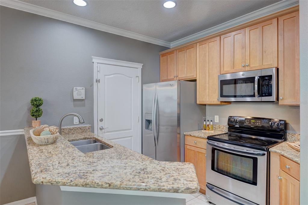 6020 Fishhawk Crossing Boulevard Lithia, FL 33547 - Photo 13 of 53 a kitchen with stainless steel appliances granite countertop a stove a microwave and a refrigerator