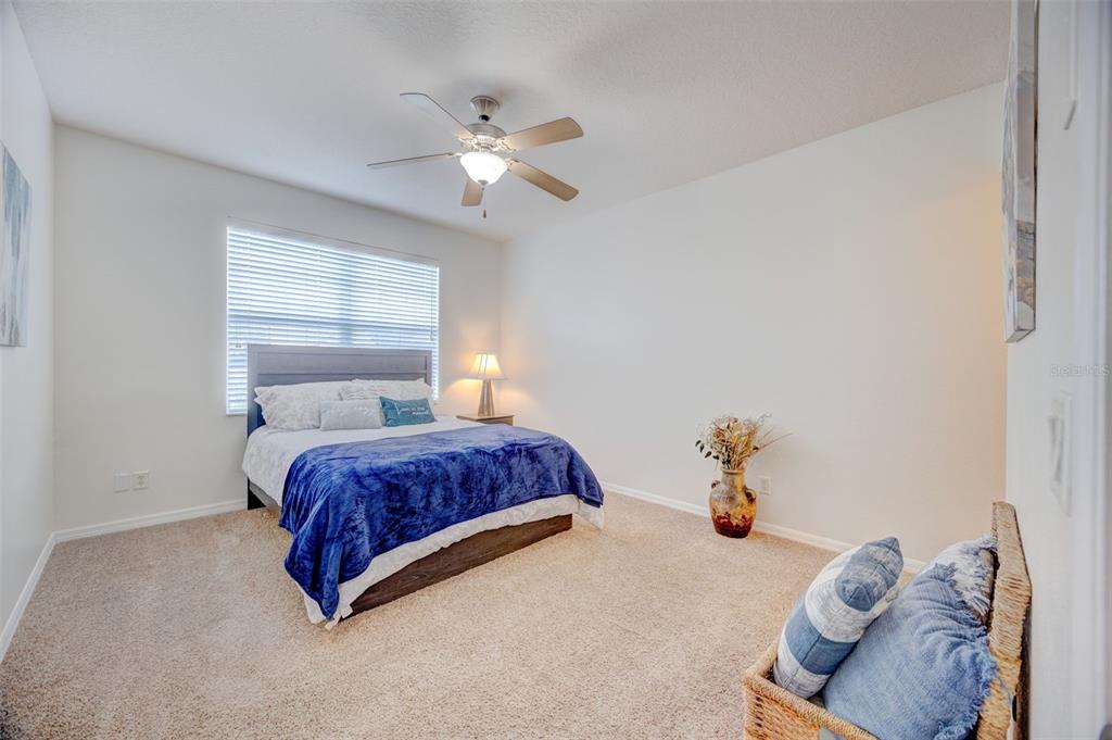 6020 Fishhawk Crossing Boulevard Lithia, FL 33547 - Photo 5 of 53 a bedroom with a bed and window