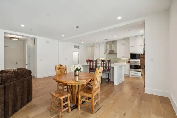 a view of a dining room with furniture and wooden floor