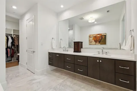 a bathroom with a double vanity sink and a mirror