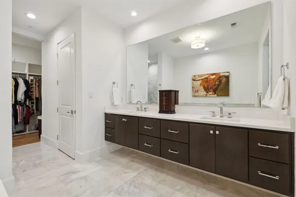 a bathroom with a double vanity sink and a mirror