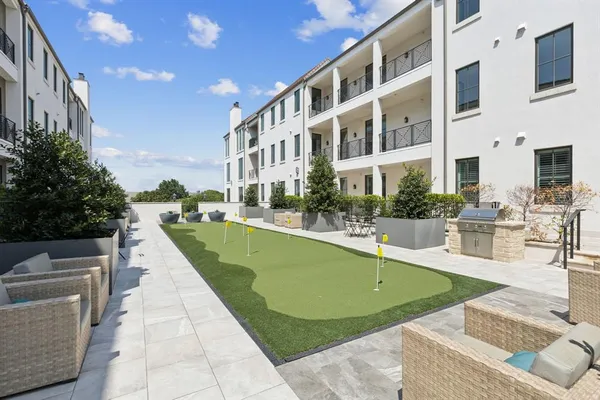 a view of a swimming pool with outdoor seating and plants