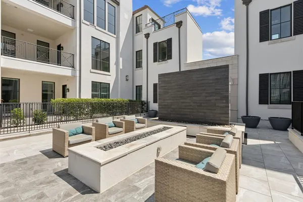 a view of an outdoor kitchen with granite countertop stove
