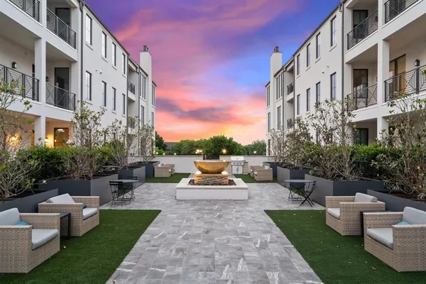 a view of the patio with couches and potted plants