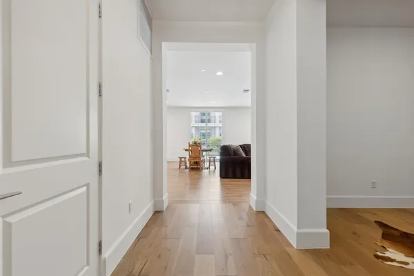 a view of living room with furniture and wooden floor