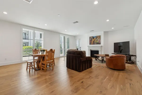 a living room with furniture a window and a flat screen tv