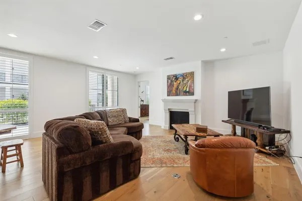 a living room with furniture a fireplace and a flat screen tv
