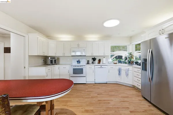 a kitchen with stainless steel appliances a refrigerator sink and cabinets