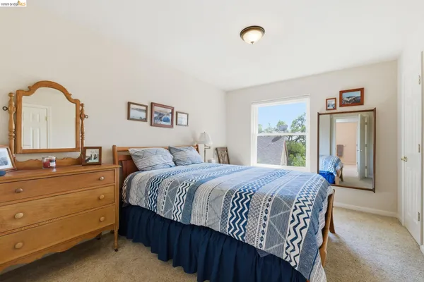a bedroom with furniture and a book shelf