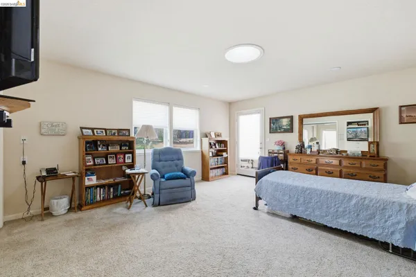 a bed room with furniture and a lamp
