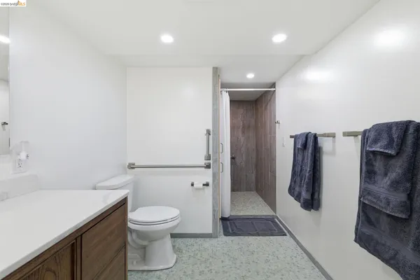 a bathroom with a toilet a sink and a shower