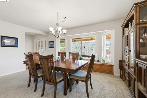 a living room with furniture a bookshelf and a large window