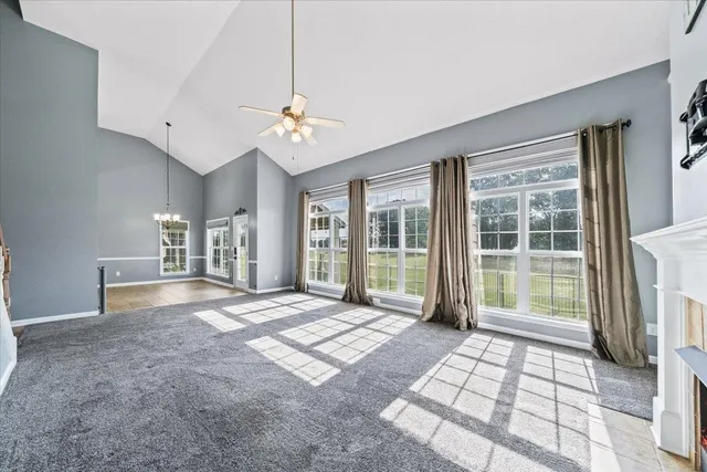 a view of hallway with windows and chandelier