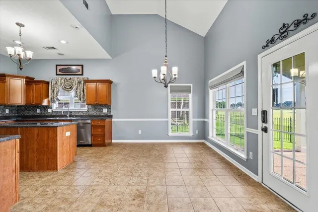 a large kitchen with granite countertop a large window and a sink