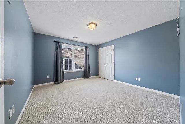 a view of a livingroom with a ceiling fan and window