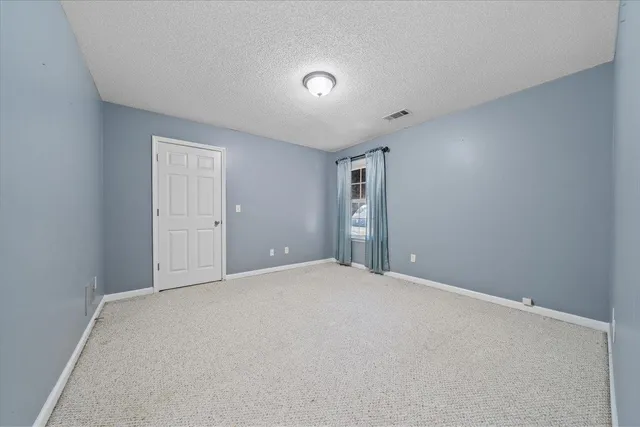 a spacious bathroom with a granite countertop sink and a mirror