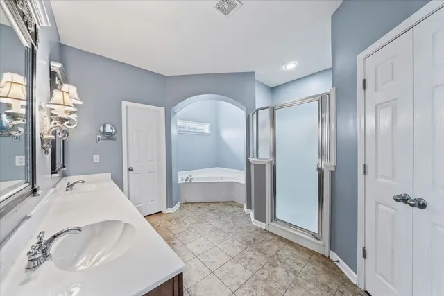 an empty room with a window and chandelier