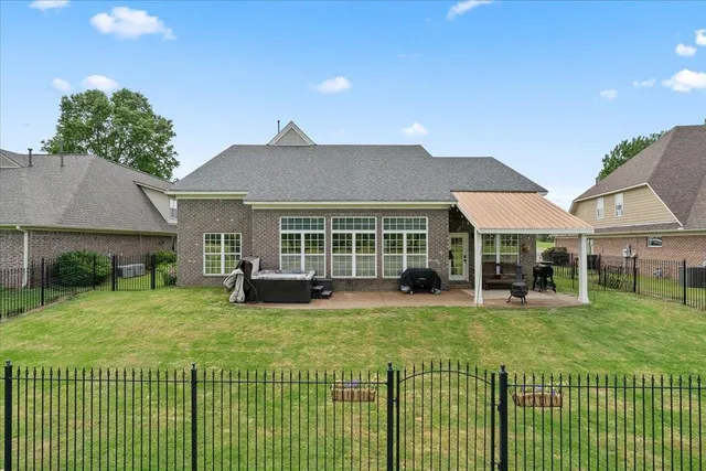 a view of a backyard with lawn chairs and a fire pit