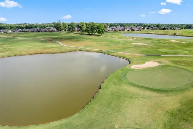 an aerial view of a house with garden space and ocean view