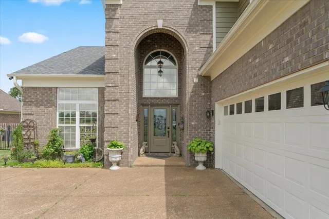 a view of a brick house with potted plants