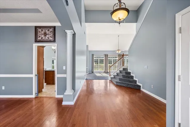 a view of a hallway with wooden floor