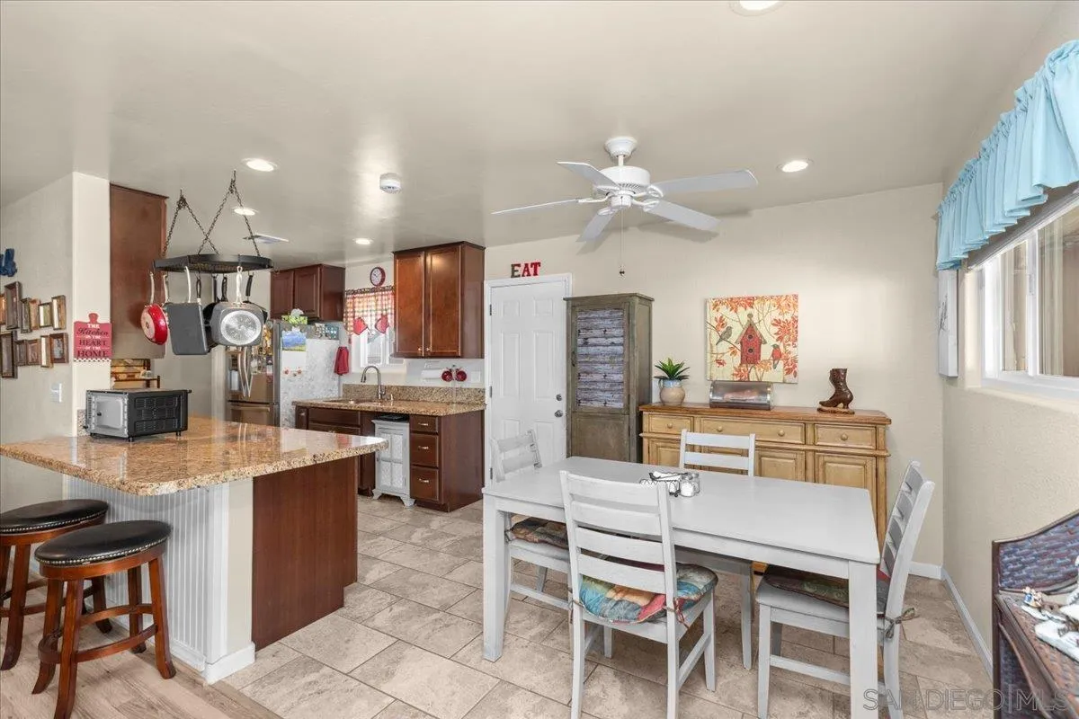 9254 Shadow Hill Road Santee, CA 92071 - Photo 10 of 34 a kitchen with kitchen island cabinets and refrigerator