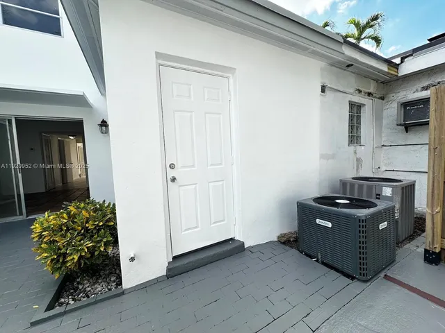 a view of a house with pool and chairs