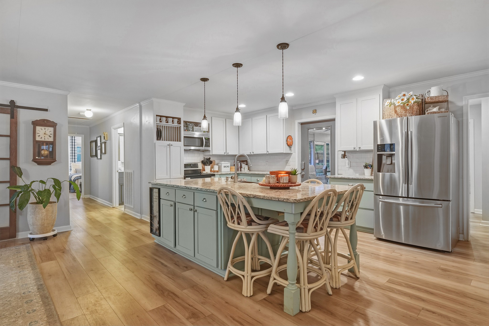 811 Hogans Branch Road Hendersonville, TN 37075 - Photo 1 of 34 a kitchen with stainless steel appliances kitchen island granite countertop a refrigerator a stove a sink a dining table and chairs with wooden floor
