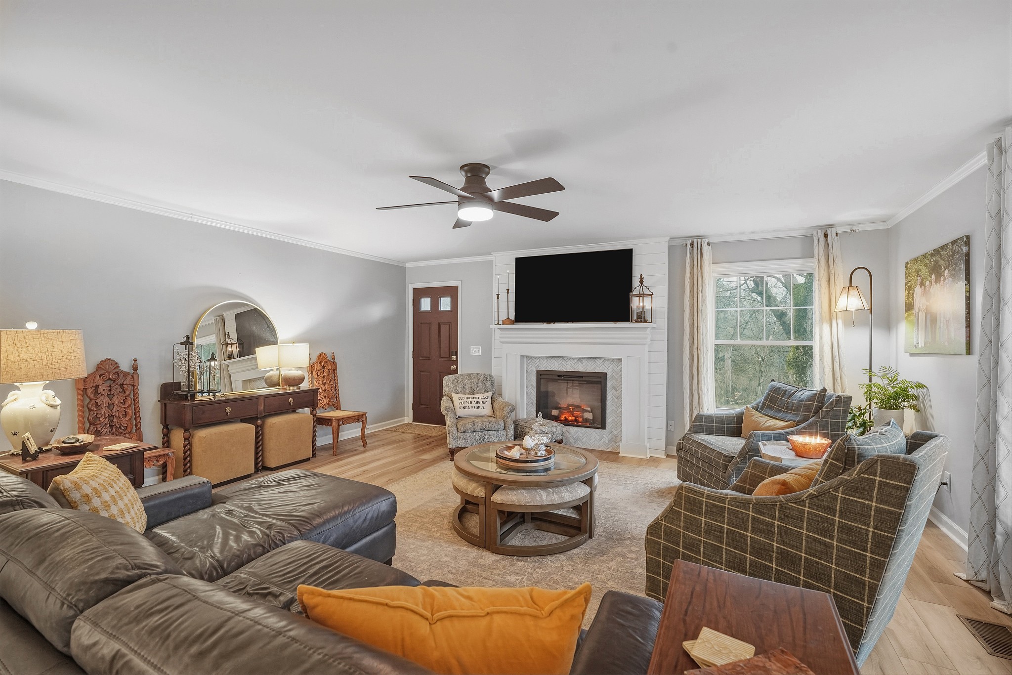811 Hogans Branch Road Hendersonville, TN 37075 - Photo 7 of 34 a living room with furniture a fireplace and a floor to ceiling window