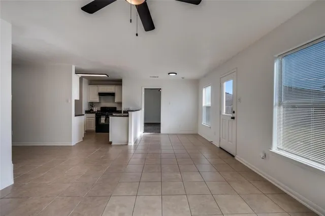 a kitchen with stainless steel appliances kitchen island granite countertop a refrigerator and a sink