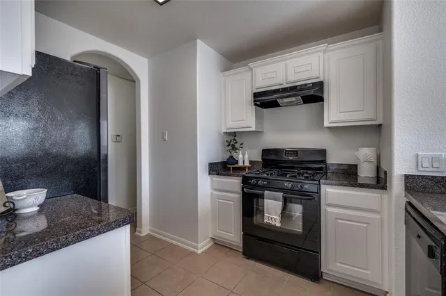 a kitchen with stainless steel appliances granite countertop a stove and a refrigerator