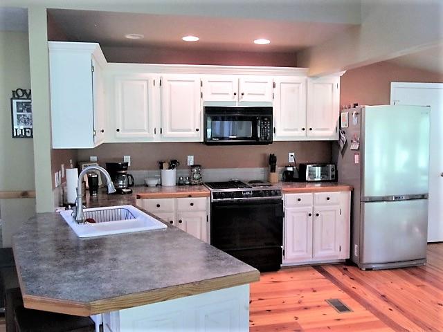 3248 Riley Creek Road Normandy, TN 37360 - Photo 10 of 24 a kitchen with granite countertop a refrigerator stove top oven and sink